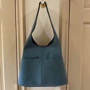 Joy Susan teal green bucket bag with removable pouch and shoulder strap.